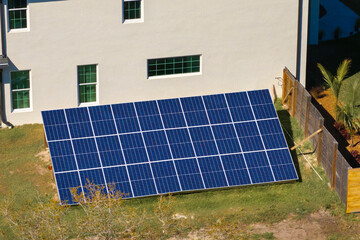 Solar photovoltaic panels mounted on stand-alone frame on backyard ground for generating of clean...