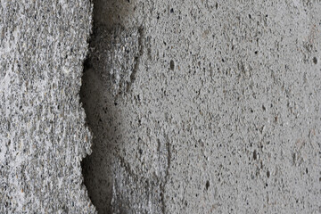 Texture of an old cracked concrete wall. Grungy gray concrete surface with shadow. Wide panoramic background for design.