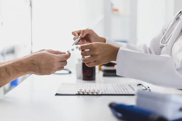 Female doctor explaining medicine dosage to patient during appointment in medical clinic. Health...
