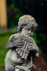 statue of an angel playing the flute