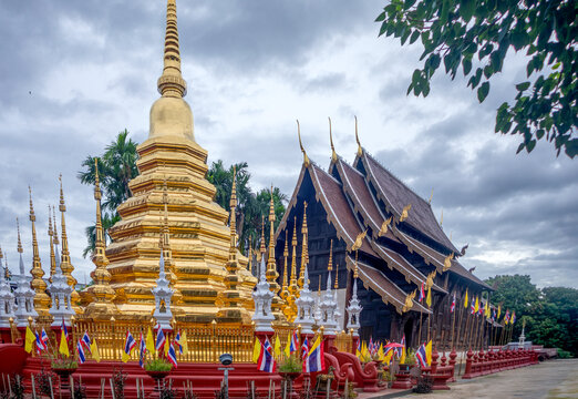 View of the Buddhist temple Wat Phantao in Chiang Mai, Thailand, with its golden chadi and wooden pavilion