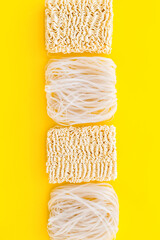Chinese and Japanese food cooking with rice vermicelli, noodles on yellow background top view mockup