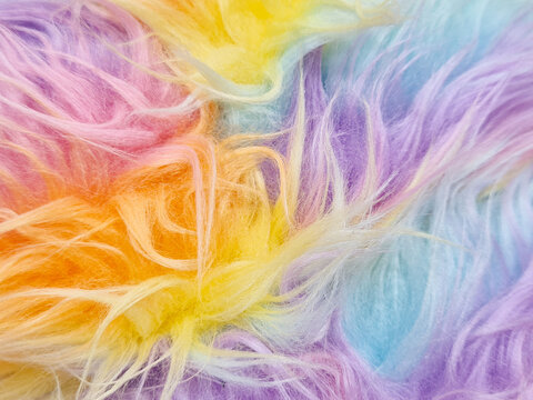 Background of rainbow-colored long pile faux fur. Long pile faux fur, also known as shaggy faux fur. Colorful made of acrylic and polyester fiber synthetic fur for decoration and various DIY projects.