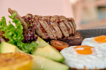 Deliciously Plated Gourmet Breakfast Featuring Grilled Steak, Fresh Greens, Eggs, and Seasonal Fruits Ready to Tempt Your Taste Buds