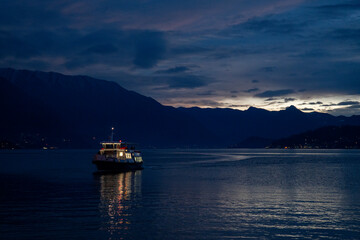 Boat Sailing at Night Over Calm Water