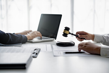 Lawyer with lawsuit meeting with client discussing with contract agreement at law firm