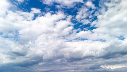 Expansive blue sky with large cumulus clouds