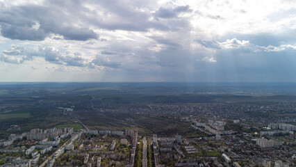 Obraz premium Wide aerial city panorama with sun rays and clouds