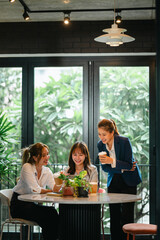 Business mentor helping trainee at office while supervisor observes and supports professional development