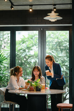 Business mentor helping trainee at office while supervisor observes and supports professional development