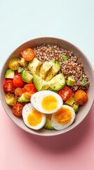 Healthy quinoa bowl with avocado, tomatoes, and eggs on a colorful background