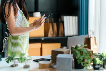 Business owner entrepreneur packing cardboard box preparing parcel for shipment, Online marketing
