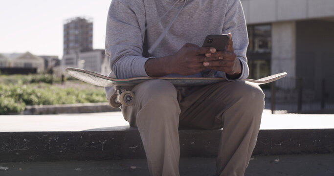 City, skateboarder and hands with smartphone, texting and communication with contact, online or web. Outdoor, skater and person with tech for chat, break and networking on social media and mobile