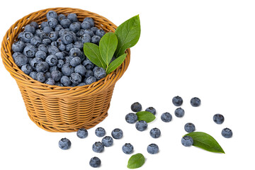 Fresh blueberries in a wicker basket with scattered berries and green leaves on white background