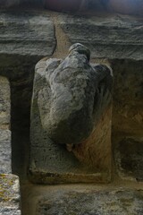 Corbel of a human figure defecating, in the Romanesque church of San Andres in Aguilar de Campoo © Agustin