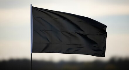 A Solemn Black Flag Billows Gently Against a Muted, Overcast Sky