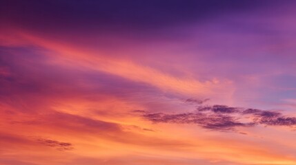 Obraz premium Colorful clouds fill a vibrant sunset sky with shades of purple and orange.