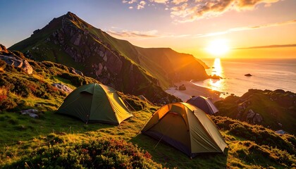 Camping adventure in mountainous coastal region during a vibrant sunset with idyllic atmosphere