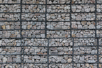 wall made by wire mesh cages  with stones at horizontal composition