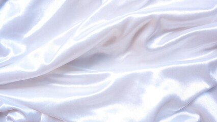 Close-up of a flowing, white satin fabric. The material has a luxurious sheen and elegant folds, creating a soft and textured background