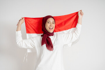 Cheerful woman holding and celebrating with the Indonesia flag, showcasing patriotism and pride...