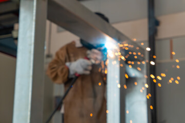 worker welding in a factory at horizonal composition