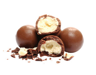 Chocolate candies with creamy filling, some pieces broken to reveal the smooth interior, creating an enticing and indulgent treat.