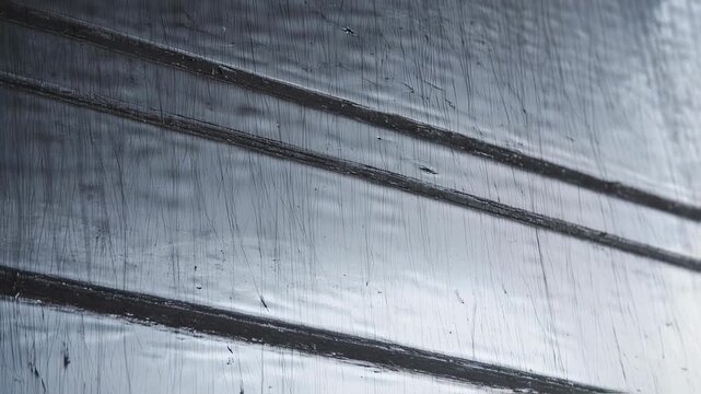 Abstract Close-Up of Textured Surface with Parallel Lines and Fine Scratches, Evoking Industrial or Natural Patterns