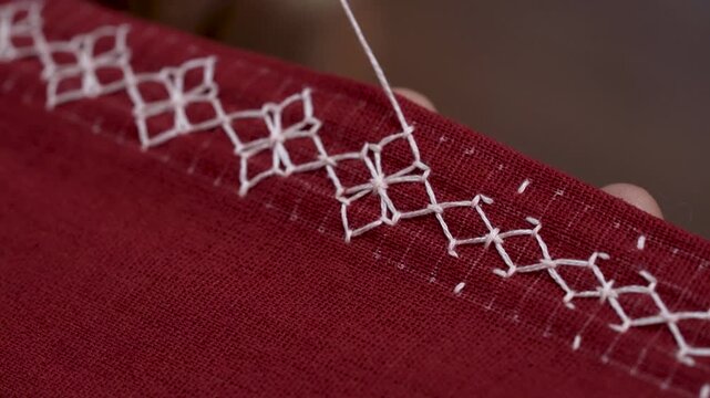 Artisan's Touch: Detailed Hand Embroidery of a Border Pattern for a Custom-Made Dress