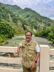 Solo tourist is posing on bridge with background of of the river in Sikkim