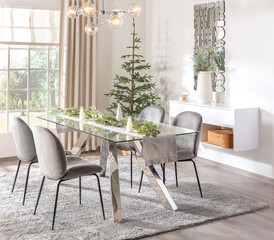 Scandinavian-style December brunch dining room with glass table, chrome legs, grey velvet chairs,...