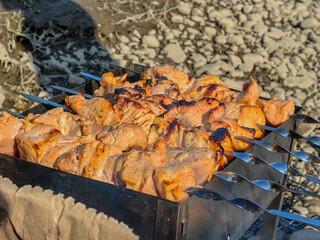 Delicious grilled skewers of meat are cooking on a barbeque, ready for a tasty meal outdoors.