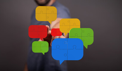 Colorful puzzle pieces forming speech bubbles symbolize teamwork, communication, and...
