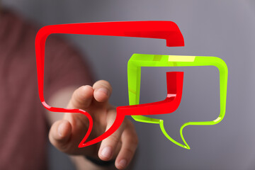 Hand interacting with 3D speech bubbles.  Ideal for communication, chat, and messaging concepts.