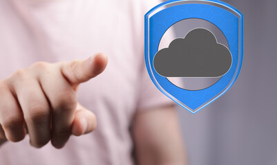 Image of a hand pointing to a cloud icon inside a shield, symbolizing secure cloud data protection.