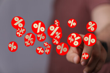 Image of a hand interacting with percentage symbols, ideal for discount, sale, finance concepts.