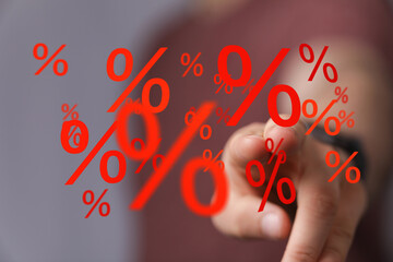 Image of a hand interacting with digital percentage signs, ideal for discount, sale, or finance...
