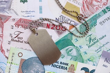 Nigerian naira currency money bills and military token. The concept of army service