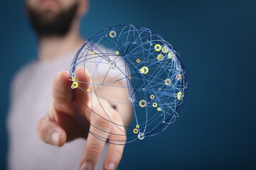 Abstract image of a hand interacting with a digital globe, representing global networking and...
