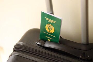 Nigerian passport on travel luggage. The concept of travel and vacation