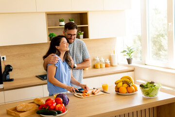 Enjoying a joyful moment in the kitchen while preparing a healthy meal together