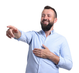 Handsome man pointing at something and laughing on white background