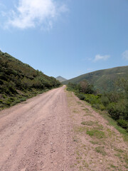 Winding earthen path through mountainous terrain, Cantabria - Escape to serenity on this peaceful rural path, surrounded by natures simplicity amidst Cantabrias majestic mountains.