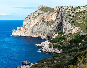 Fototapeta premium Coastal cliffs meet a deep blue sea