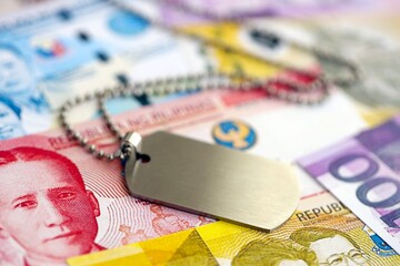Philippines peso currency money bills and military token. The concept of army service