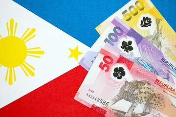 Philippines peso currency money bills lies on flag. The concept of business and investment