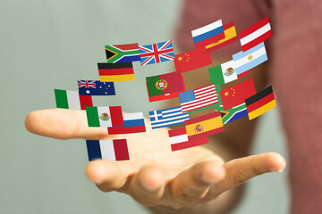 Image of a hand holding various national flags, symbolizing global unity and international...
