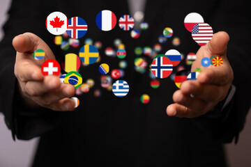 Image of hands holding various country flags, symbolizing global business and international connections.