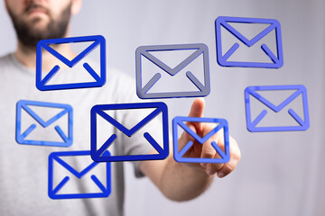 Person using touchscreen, selecting emails.  Digital communication concept.