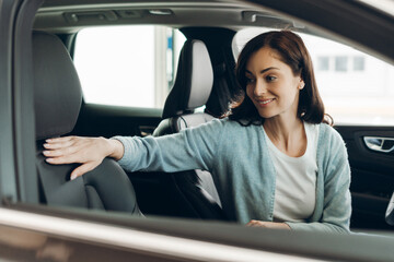 Customer touching seat in new car showroom
